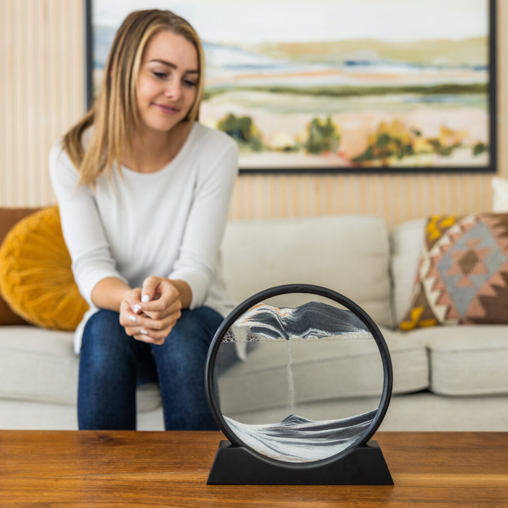 Woman watching flowing sand art